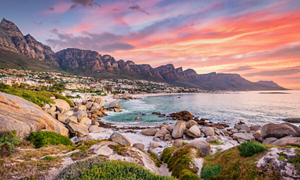 Beautiful sunset twilight view to Camps Bay, Scenic view during colorful sunset with beautiful cloudscape. Camps Bay the famous suburb of the city of Cape Town with white sandy beaches underneath the Table Mountain. Camps Bay, Cape Town, South Africa, Africa